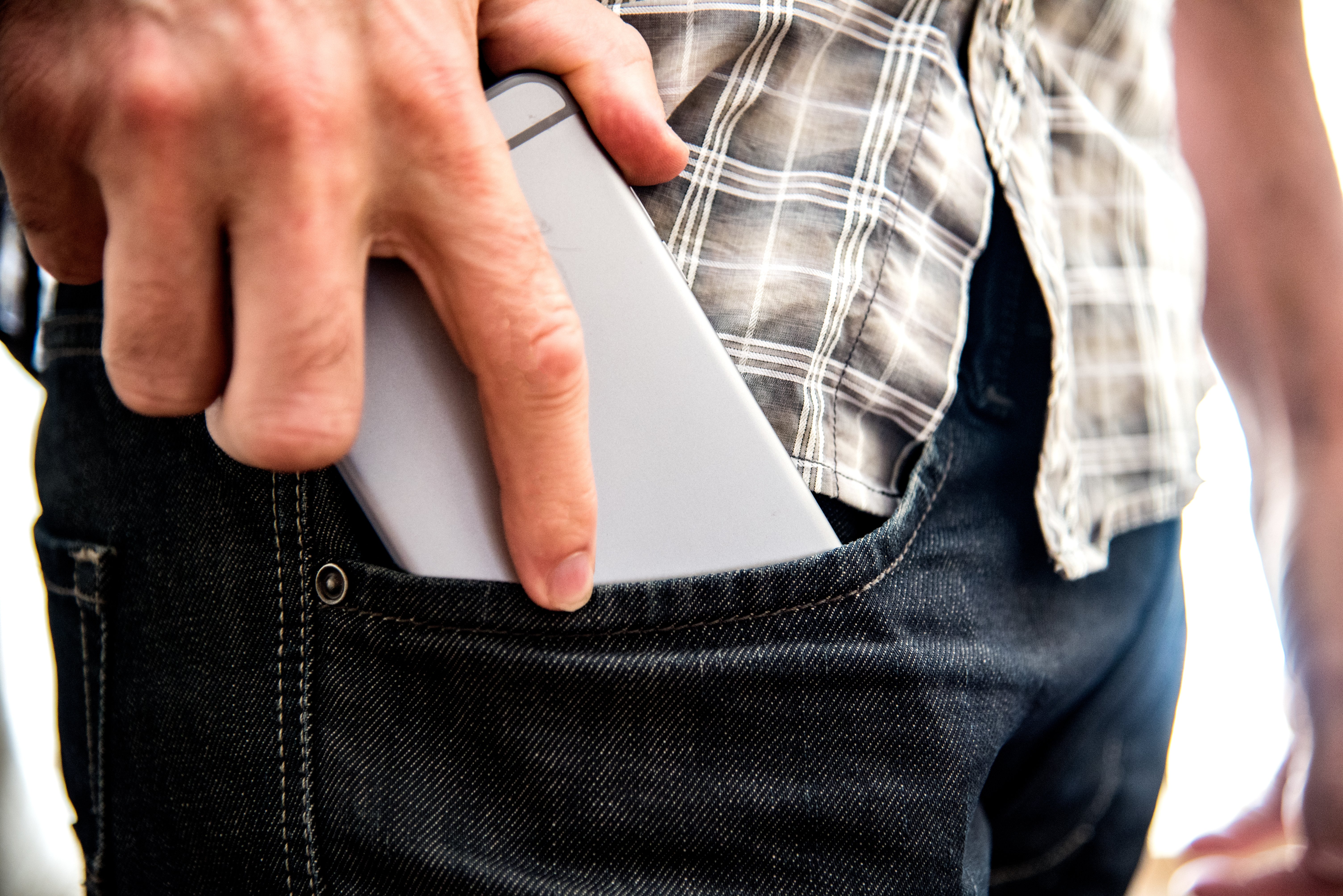 putting-cell-phone-in-pocket-872ABTA